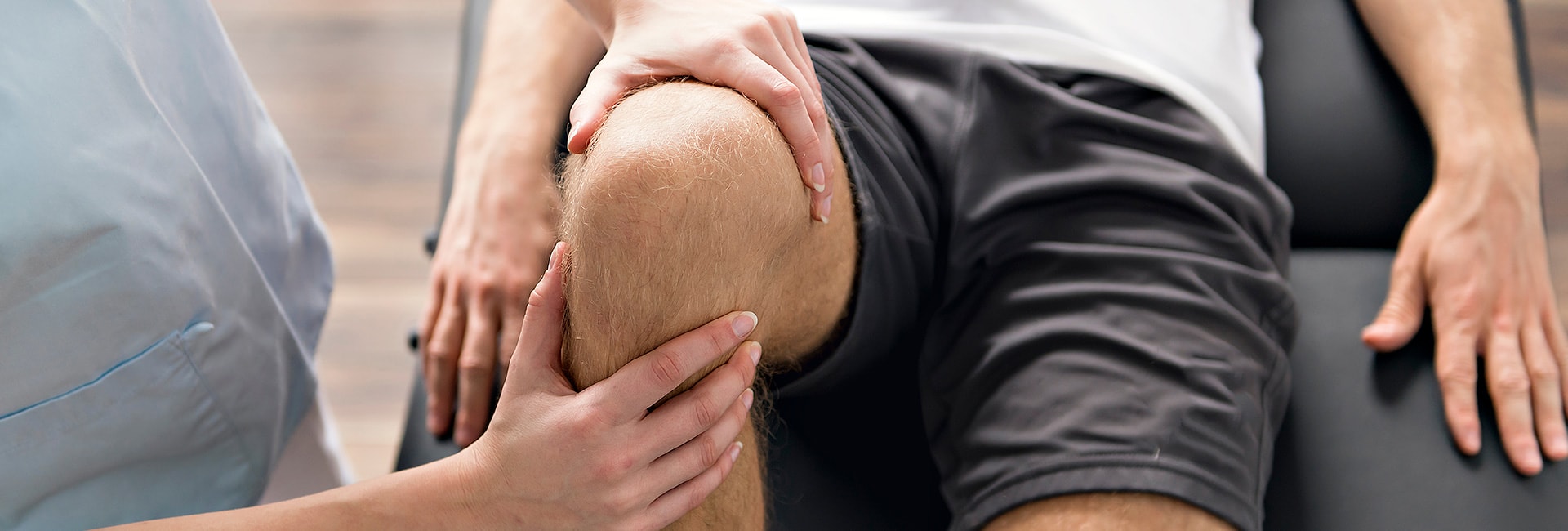 Therapists examines patients knee