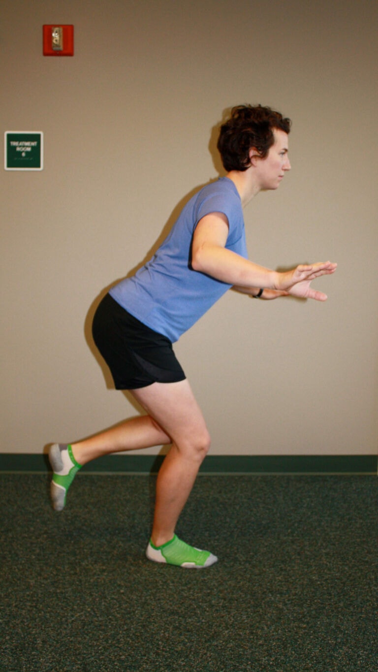 PT demonstrates a single leg squat exercise
