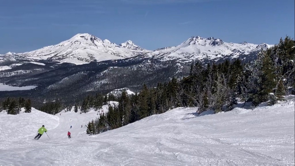 Skiers at Mount Bachelor with the Cascade Mountains in view