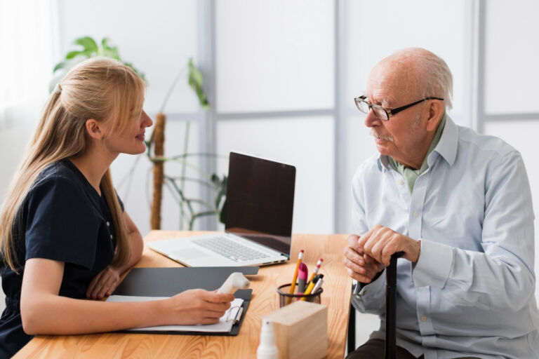 an older gentleman has help from an administrative assistant at his appointment