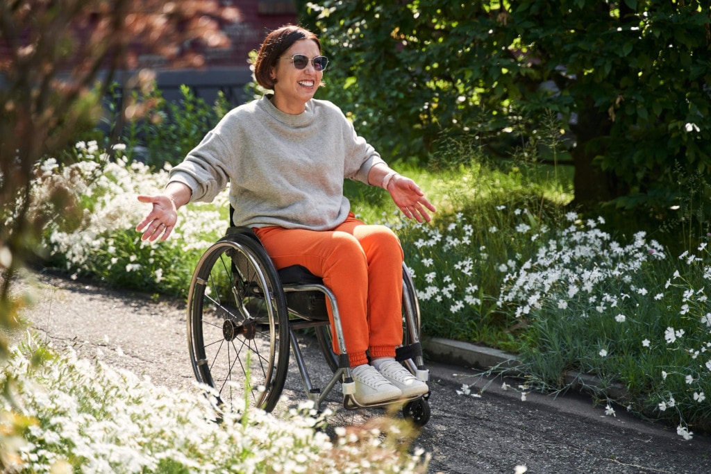 woman in wheelchair happy and appreciating a sunny day
